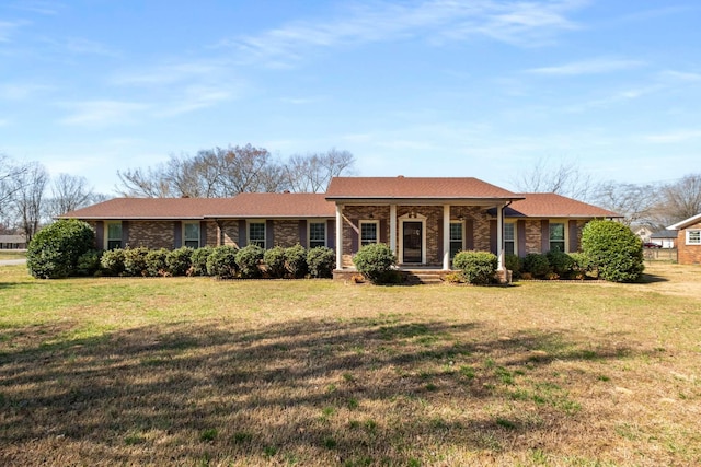 single story home with brick siding, a porch, and a front lawn