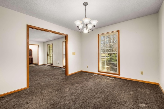 unfurnished room featuring visible vents, baseboards, an inviting chandelier, a textured ceiling, and dark colored carpet