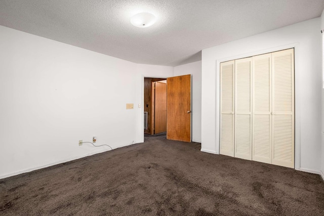 unfurnished bedroom with a closet, carpet, and a textured ceiling