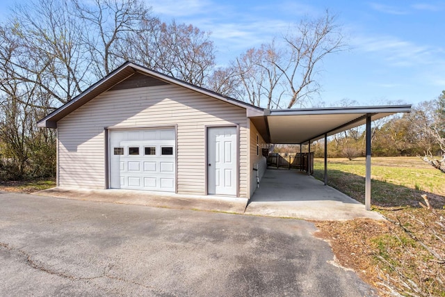 garage with a detached garage and driveway