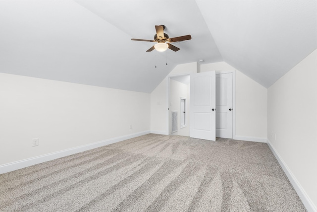 bonus room featuring visible vents, baseboards, lofted ceiling, light carpet, and a ceiling fan