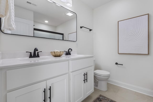 full bathroom with double vanity, visible vents, toilet, and a sink