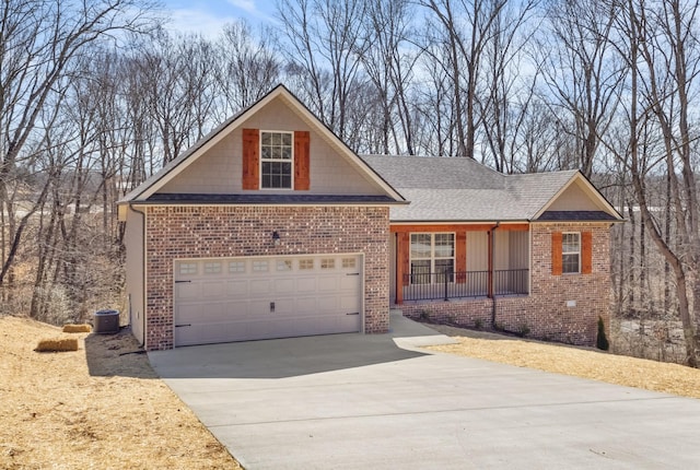 view of front of home with brick siding, central AC, concrete driveway, and a garage