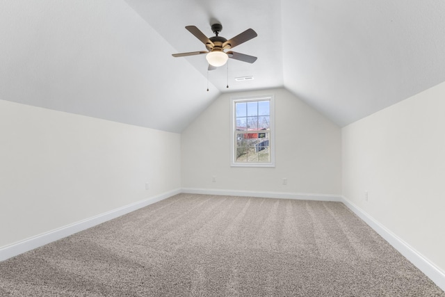 bonus room with light carpet, a ceiling fan, baseboards, and vaulted ceiling