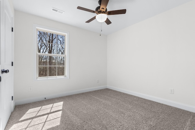 unfurnished room featuring a ceiling fan, carpet flooring, baseboards, and visible vents