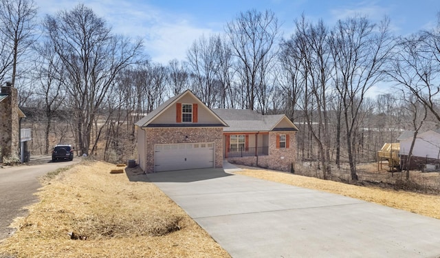 view of front of home featuring brick siding and driveway