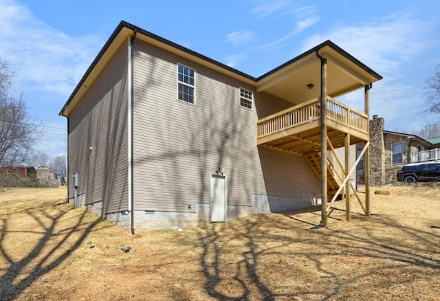 view of property exterior featuring a deck, stairway, and crawl space