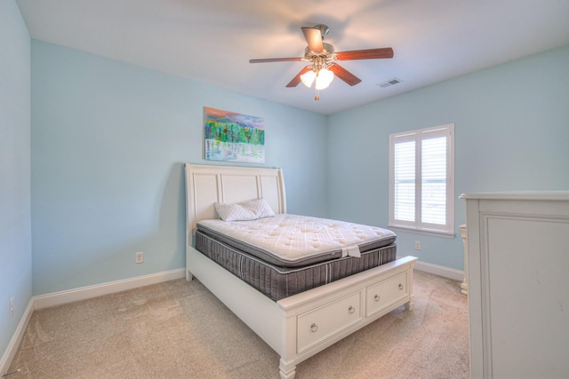 bedroom with light carpet, visible vents, ceiling fan, and baseboards