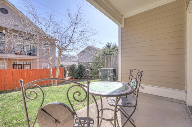 view of patio featuring cooling unit and fence