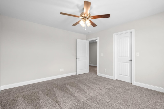 unfurnished bedroom with carpet flooring, a ceiling fan, and baseboards