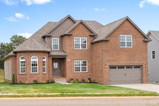 view of front facade with a front yard, brick siding, driveway, and roof with shingles