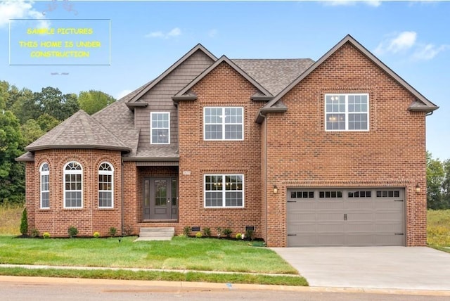 view of front of home featuring a front lawn, roof with shingles, concrete driveway, an attached garage, and brick siding