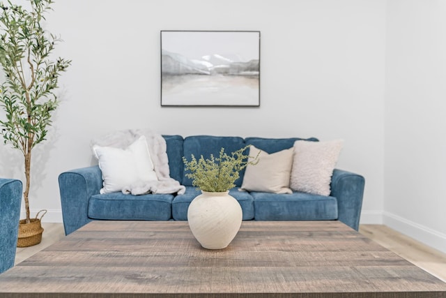 sitting room featuring baseboards and wood finished floors