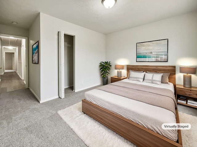 bedroom featuring a closet, carpet flooring, attic access, and baseboards