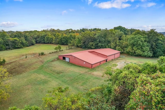 aerial view featuring a view of trees and a rural view