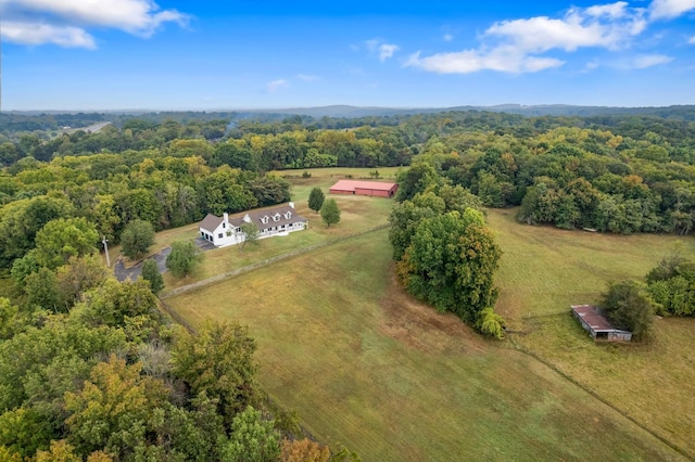 drone / aerial view featuring a rural view and a view of trees