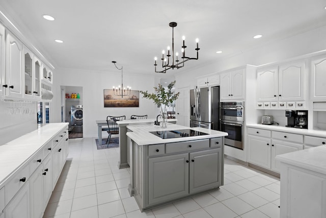 kitchen featuring light countertops, gray cabinets, an inviting chandelier, white cabinets, and stainless steel appliances