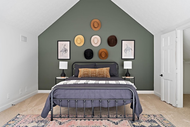 bedroom with vaulted ceiling, visible vents, baseboards, and carpet floors