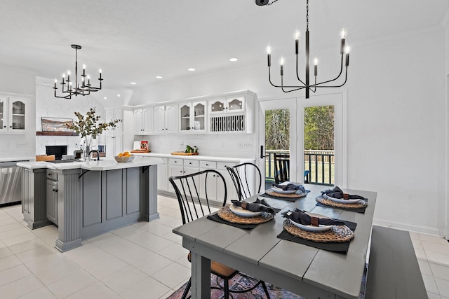 dining room featuring a fireplace, a notable chandelier, recessed lighting, and light tile patterned floors