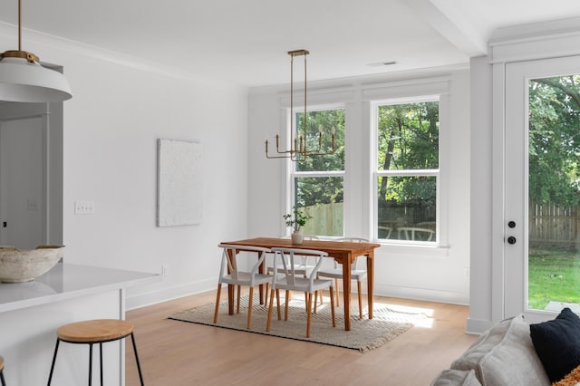 dining space featuring light wood-style flooring and baseboards