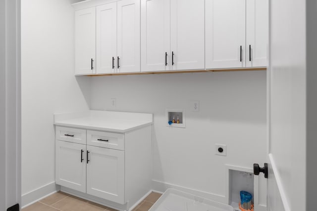 laundry room featuring light tile patterned floors, baseboards, cabinet space, electric dryer hookup, and washer hookup