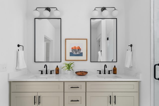 full bathroom featuring double vanity, a shower stall, and a sink