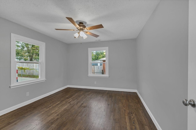 empty room featuring a ceiling fan, baseboards, a textured ceiling, and dark wood-style flooring