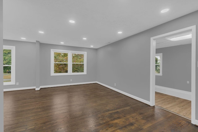 spare room with a wealth of natural light, dark wood-type flooring, and recessed lighting