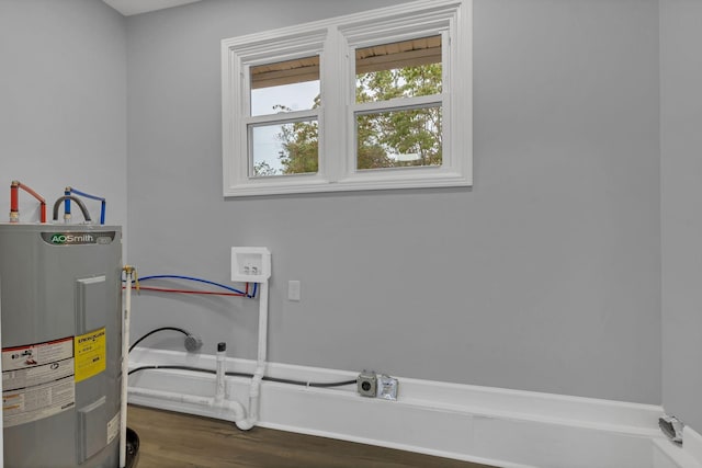 laundry area featuring electric water heater, washer hookup, laundry area, wood finished floors, and hookup for an electric dryer