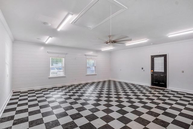 spare room with attic access, baseboards, and ornamental molding