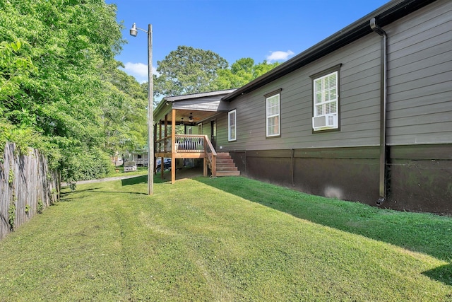 view of yard featuring stairs, a ceiling fan, fence, and a wooden deck