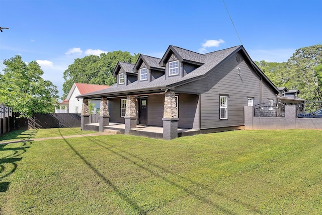 back of house with a patio area, a lawn, and fence