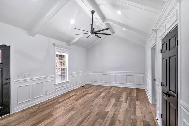 interior space featuring lofted ceiling with beams, wood finished floors, and a ceiling fan