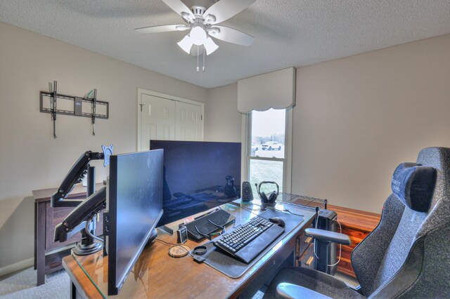 office area featuring a ceiling fan and a textured ceiling