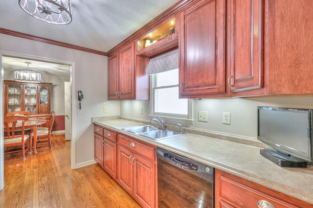 kitchen with a sink, black dishwasher, a textured ceiling, light wood finished floors, and light countertops