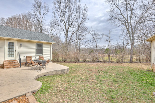 view of yard featuring entry steps and a patio area