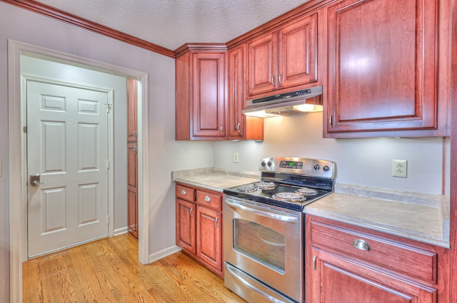 kitchen featuring light countertops, stainless steel electric stove, light wood-style floors, and under cabinet range hood