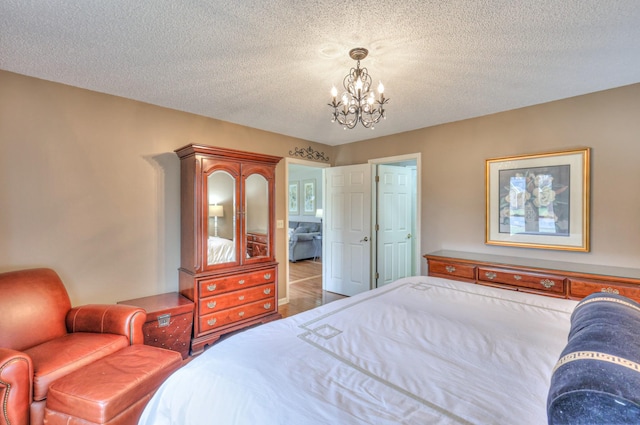 bedroom with a textured ceiling and a chandelier