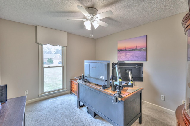 office featuring plenty of natural light, visible vents, carpet floors, and a textured ceiling