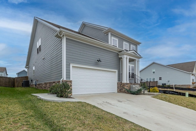 view of front of house featuring a front yard, fence, concrete driveway, a garage, and brick siding