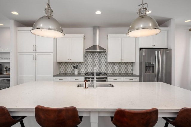 506B 36th Ave N, Nashville, TN 37209 - kitchen with appliances with stainless steel finishes, wall chimney range hood, a sink, tasteful backsplash, and decorative light fixtures