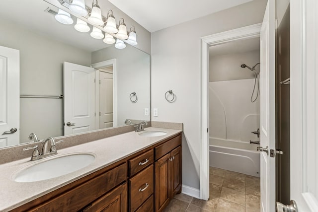 full bathroom featuring double vanity, tile patterned floors, shower / bathtub combination, and a sink