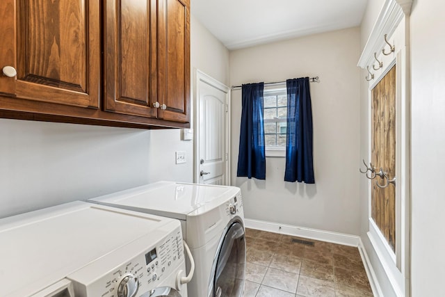 laundry area with cabinet space, visible vents, washer and dryer, and baseboards