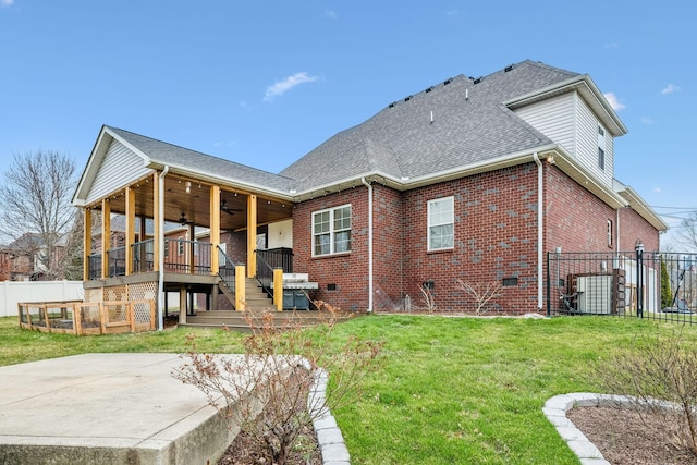 back of house with crawl space, brick siding, a ceiling fan, and fence