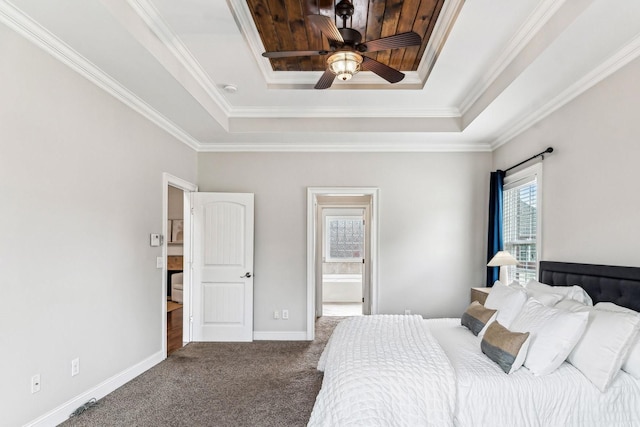 bedroom with baseboards, a raised ceiling, carpet flooring, and crown molding