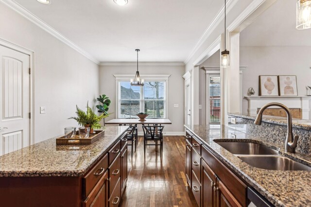 kitchen with a sink, stainless steel dishwasher, dark wood-style floors, and ornamental molding