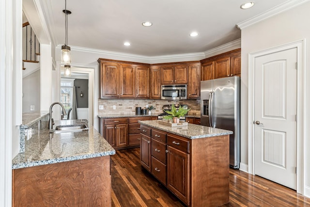 kitchen featuring a sink, stainless steel appliances, light stone countertops, and dark wood finished floors