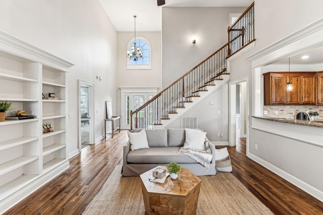 living area featuring dark wood finished floors, stairway, and a healthy amount of sunlight