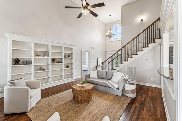 living area featuring stairway, visible vents, dark wood-style flooring, and baseboards