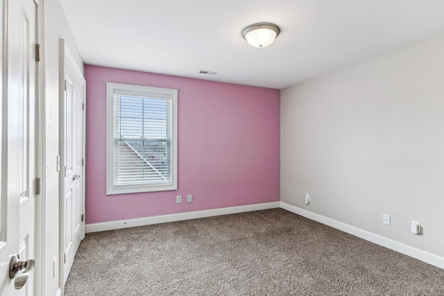 unfurnished room with carpet flooring, baseboards, and visible vents